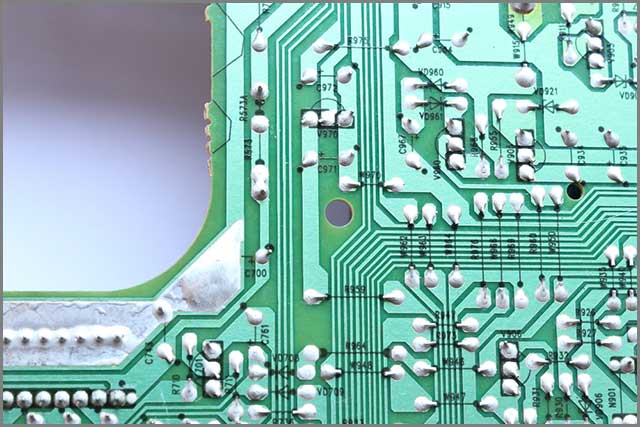 PCB with a section of solder mask on a trace removed and additional solder added