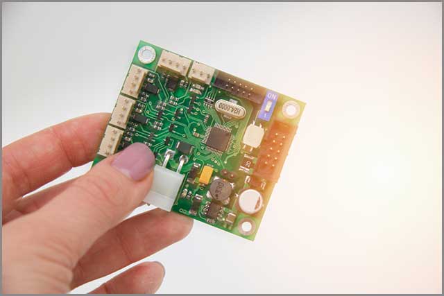 A person holding a PCB chip assembly