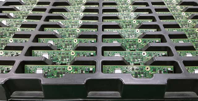 A close up of circuit boards in a tray
