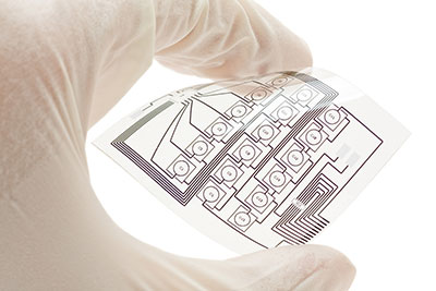 Flexible printed circuit board held by a human hand