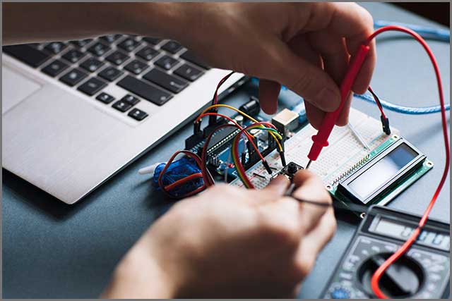 An image of a person closely examining a PCB