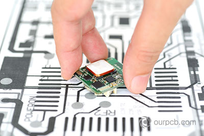 A PCB prototype as compared to the initial design