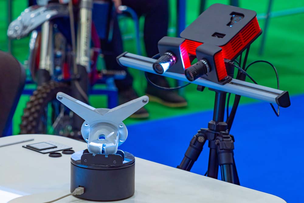 A 3D scanner acquires dimensional data from an object.