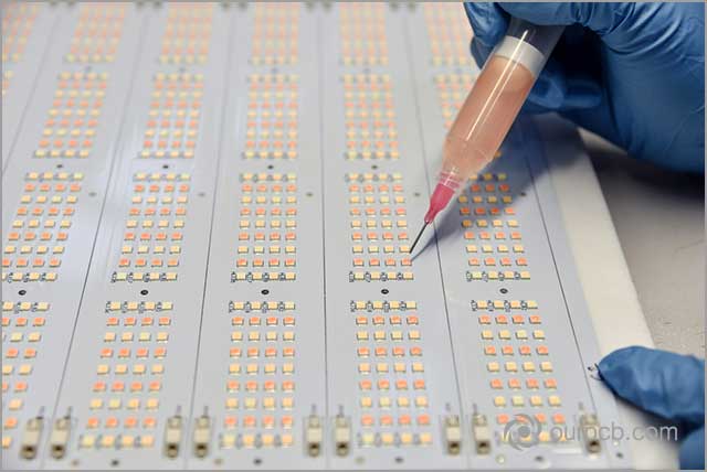 an engineer working on a PCB board for led
