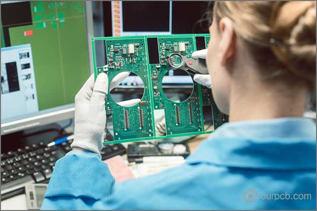 A technician in a prototype PCB supplier’s workshop inspecting quality standards