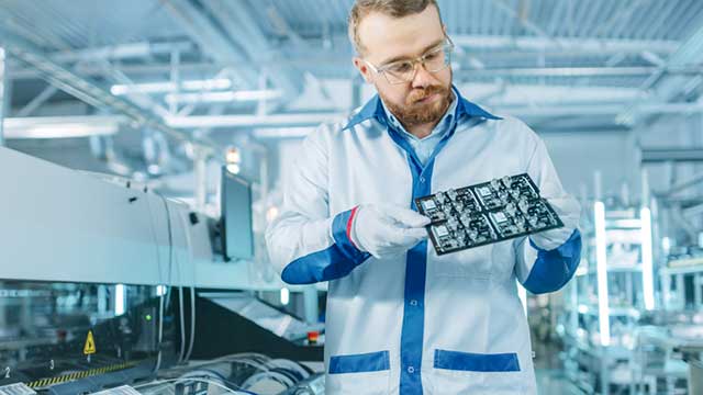 A technician inspecting a HASL finished board