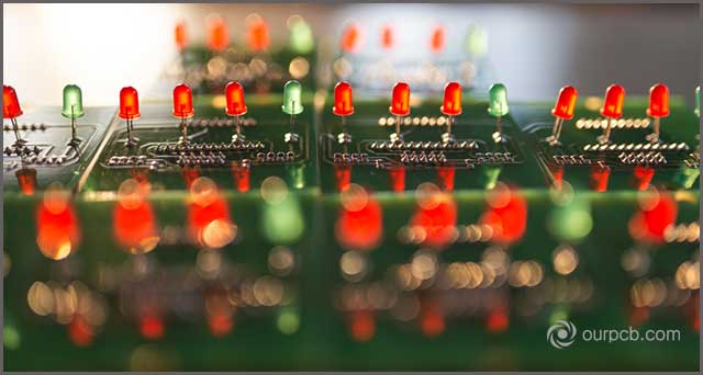 Red and green light bulbs displayed on a PCB panel