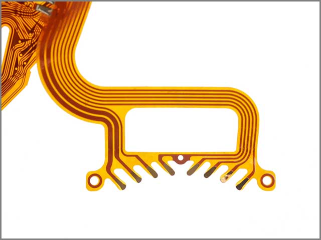 Detail of flexed printed circuit on white background