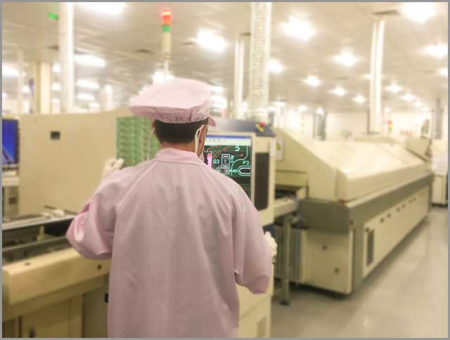 An engineer working on an AOI tester