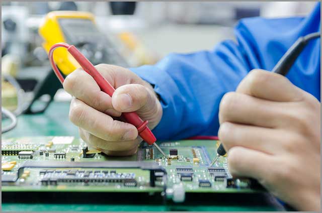 engineer measuring multimeter panel board