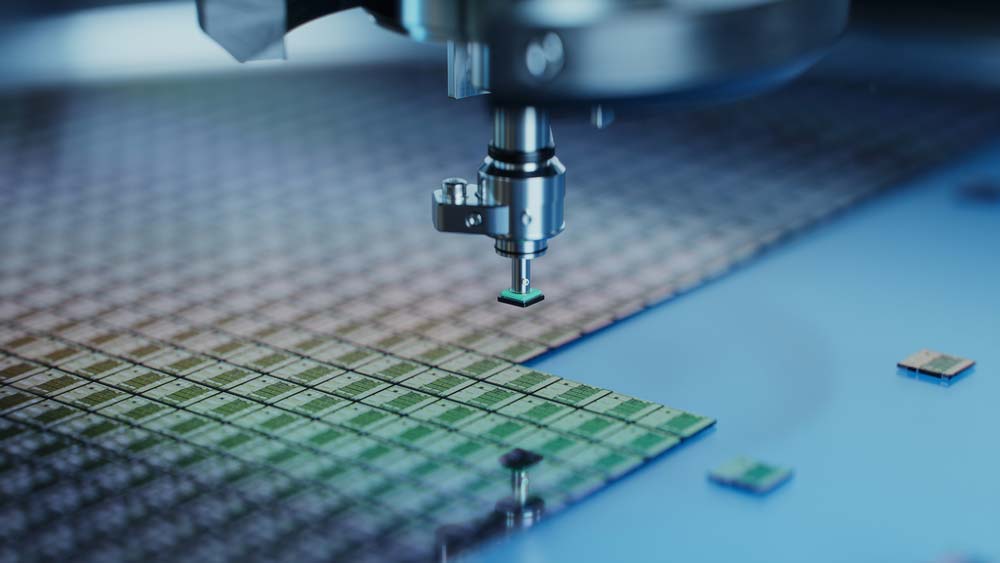 Multiple computer chips being extracted from a wafer for packaging