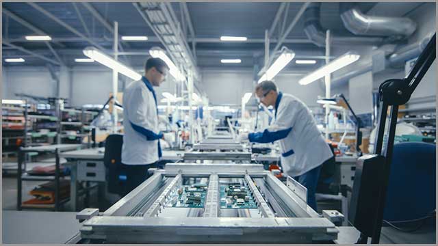 Factory workers assembling PCBs