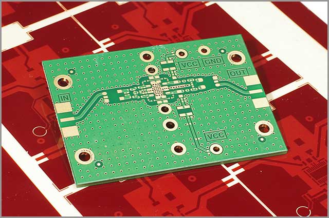 A multilayered PCB on a red background