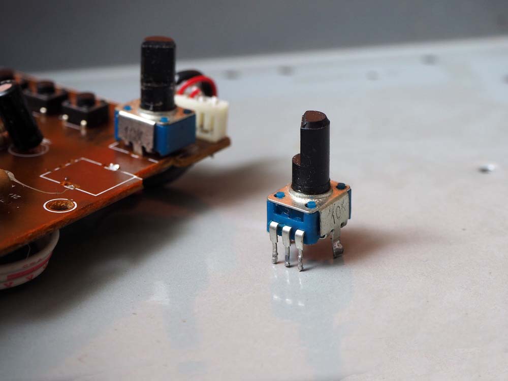 A 10kilo-ohm concentric potentiometer next to a PCB