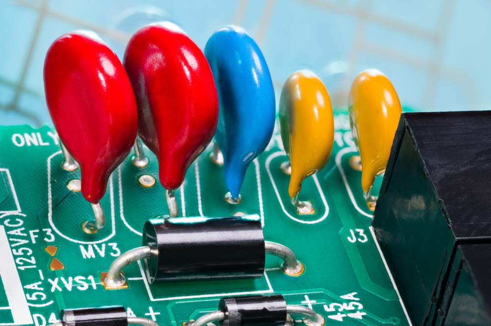 Multiple colored varistors on a green PCB