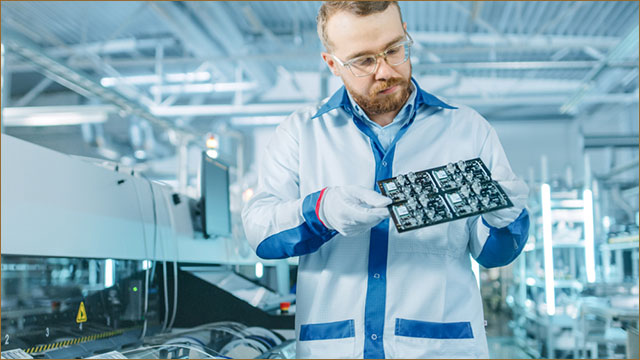 Inspector checking the design of castellated holes PCB