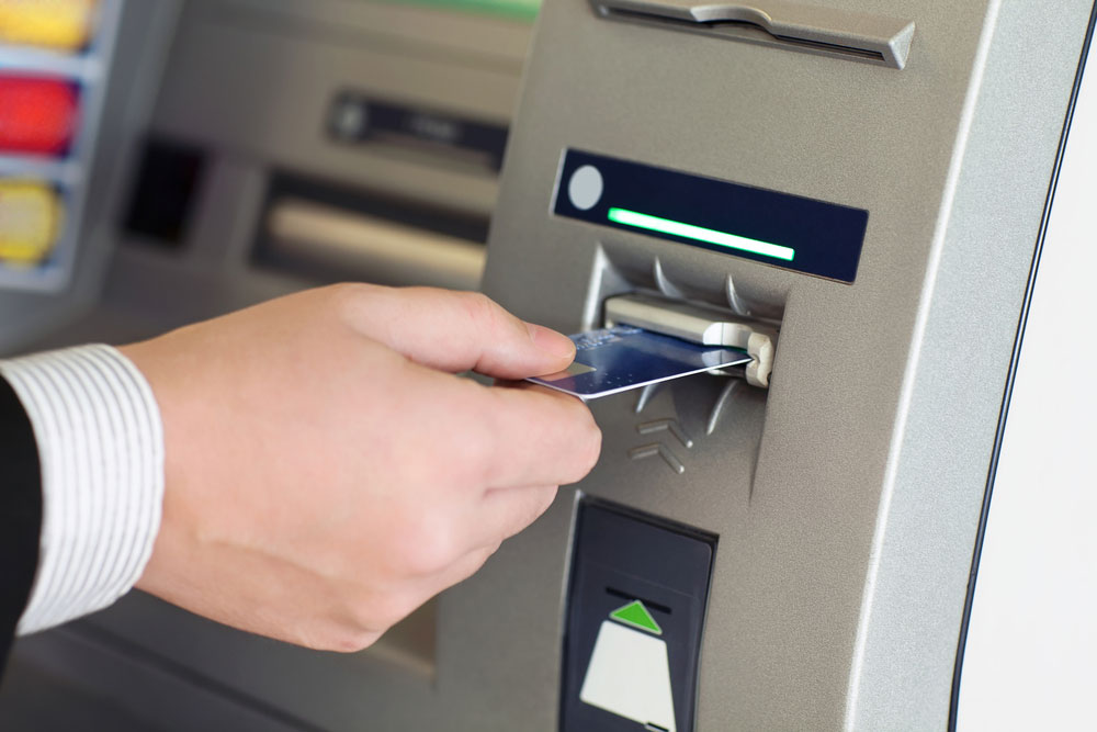 Male inserting card into ATM