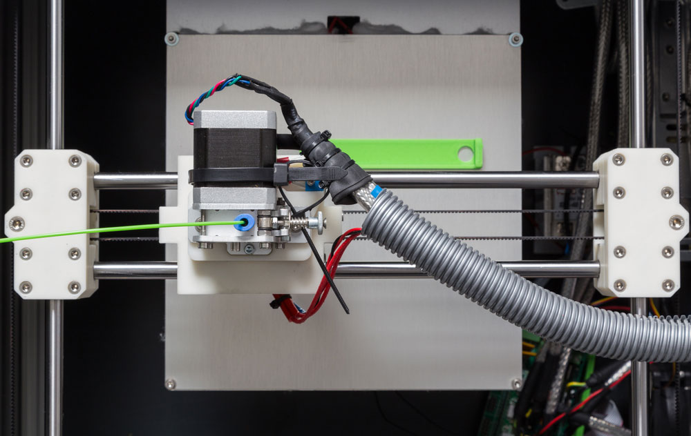 3D printer with bright green filament