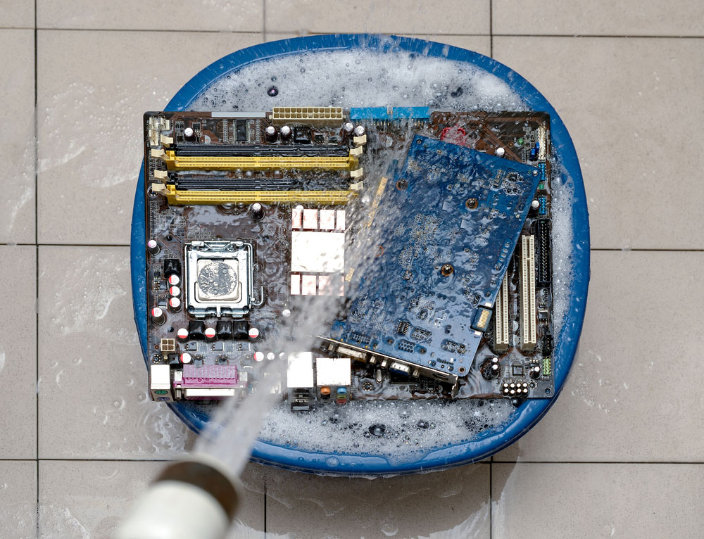 A hose drenching a set of PCBs in water