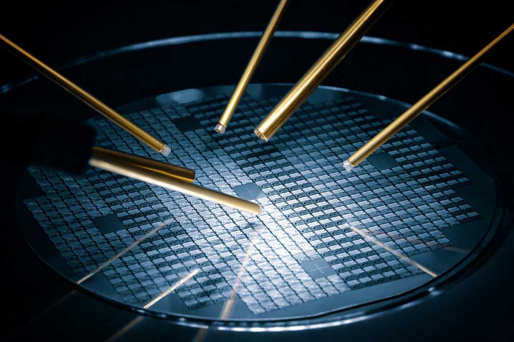 A test sample of a miniaturized integrated circuit under a microscope