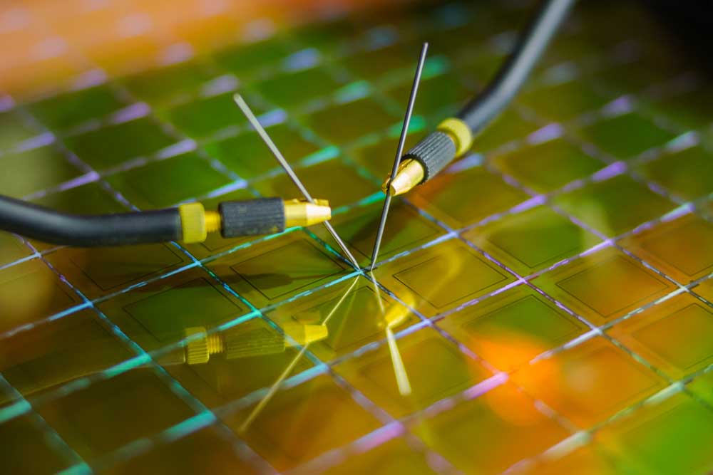 Machine probing microchips on a silicon wafer