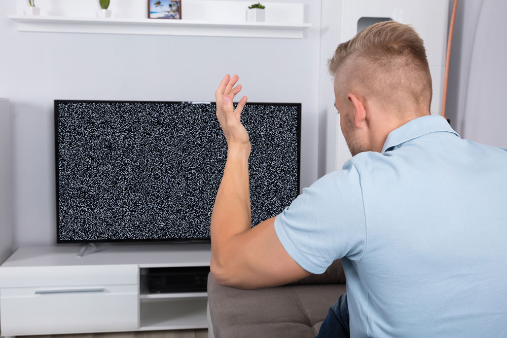 a picture of a frustrated man over poor tv signal