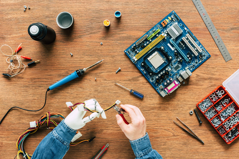 an image of a person assembling materials on a circuit board
