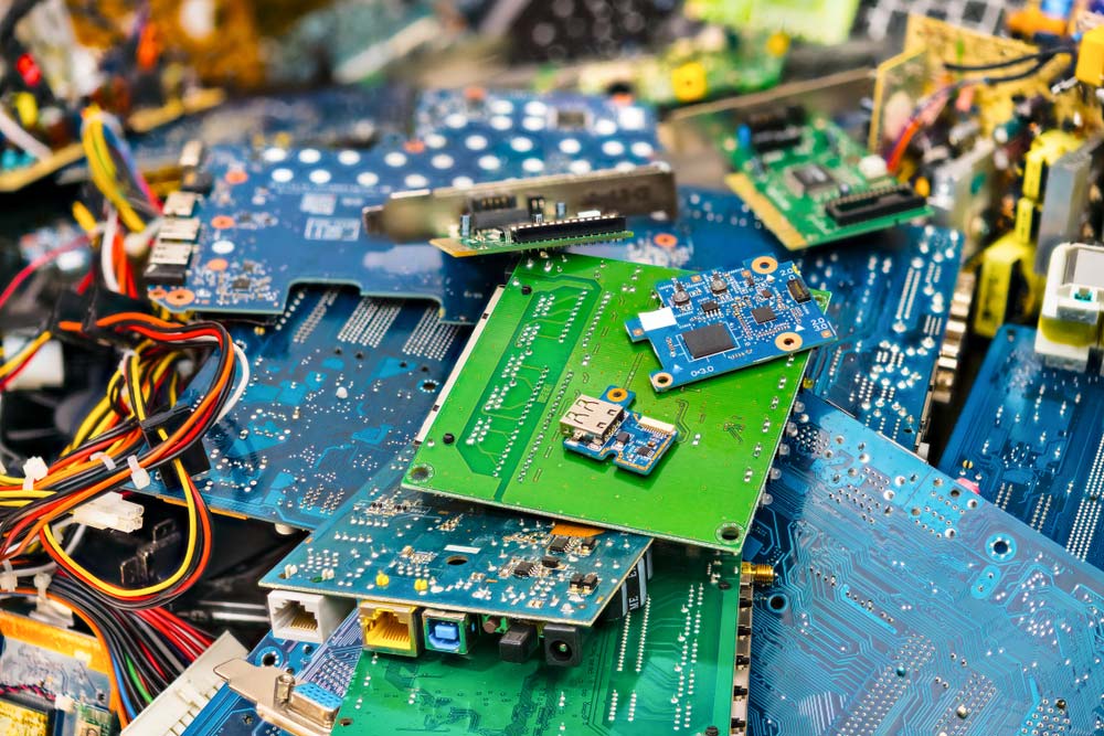 A heap of e-waste from discarded laptop PCBs and parts