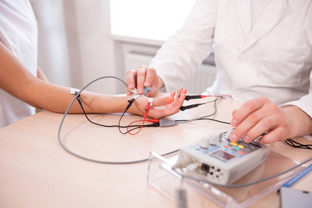 A patient doing nerve tests using a surface-type EMG sensor