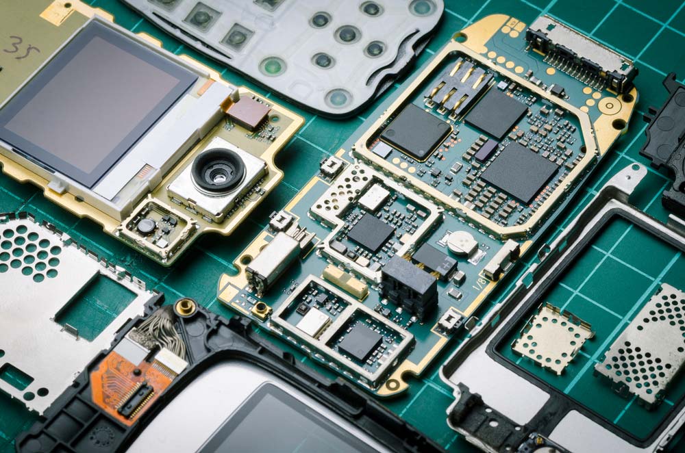 An old phone’s PCB with valuable parts like semiconductors and gold surface finishes