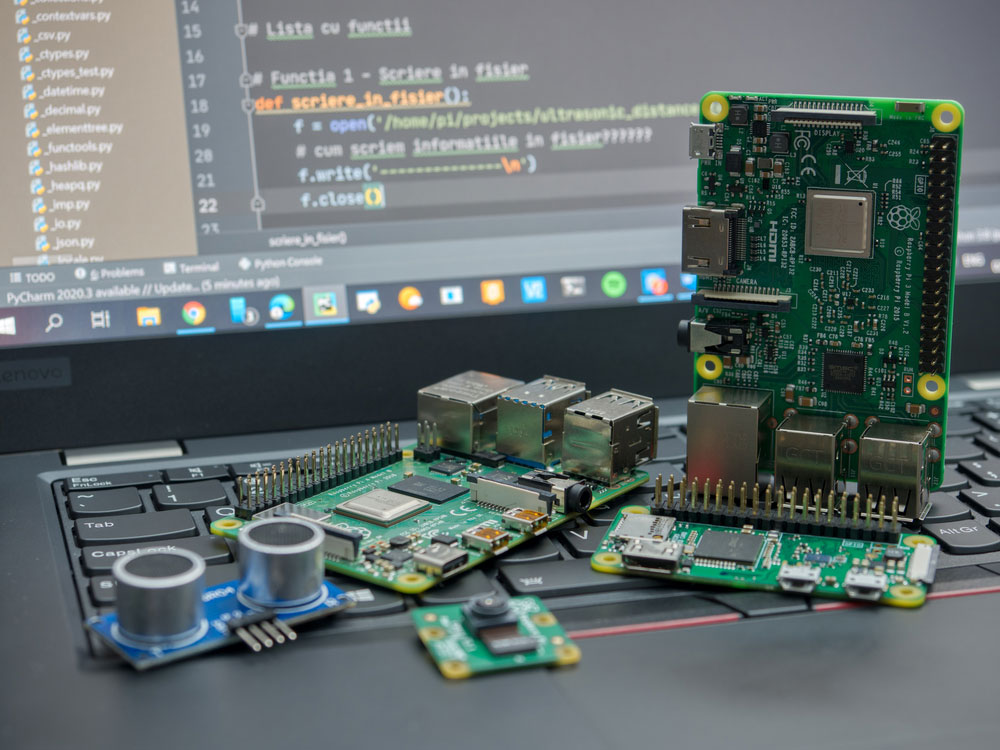 Close-up of Raspberry Pi 4 Model-B, Raspberry Pi 3 Model-B, and Raspberry Pi Zero W on a laptop keyboard