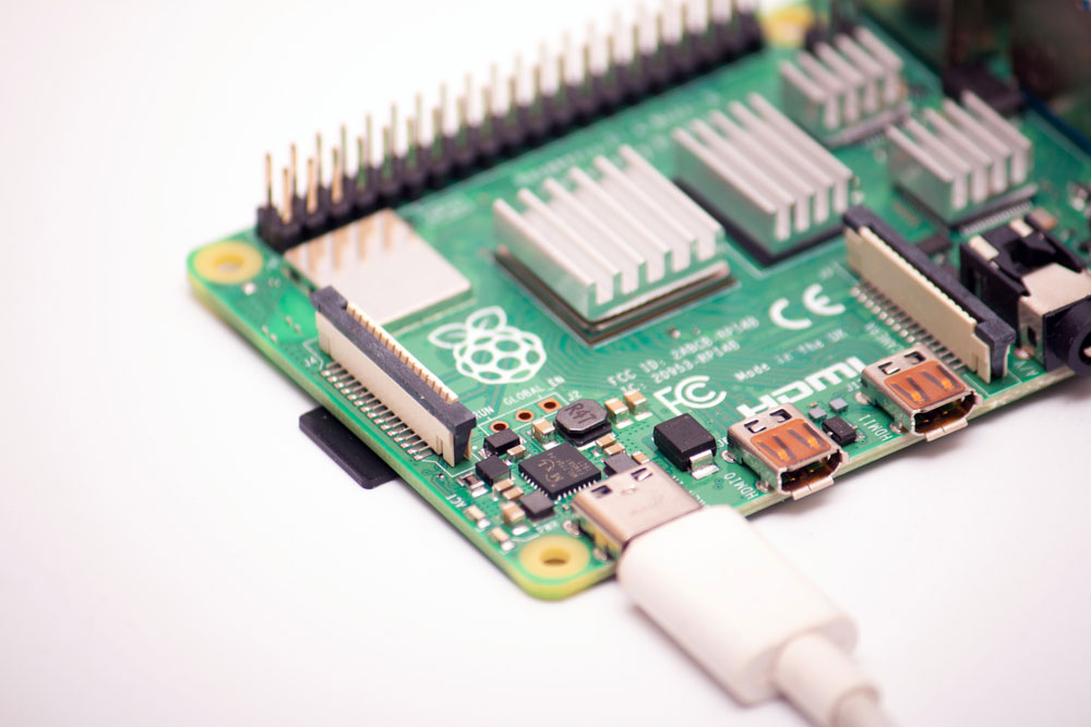 Connected to a power supply by USB 3.0 type C cord SBC budget microcomputer Raspberry Pi 4B.