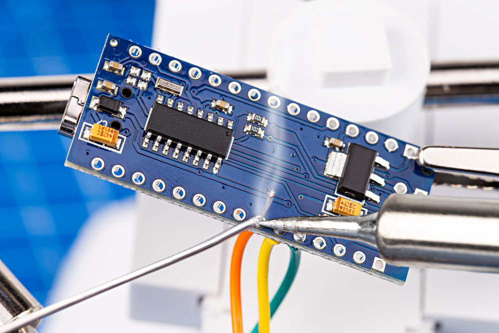 Soldering pins and wires to Arduino microcontroller