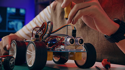 Young student with Arduino-based robotics project