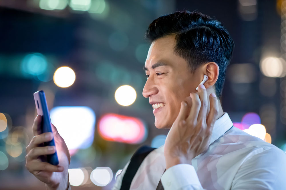 A guy listening to music using Bluetooth Wireless Earbuds