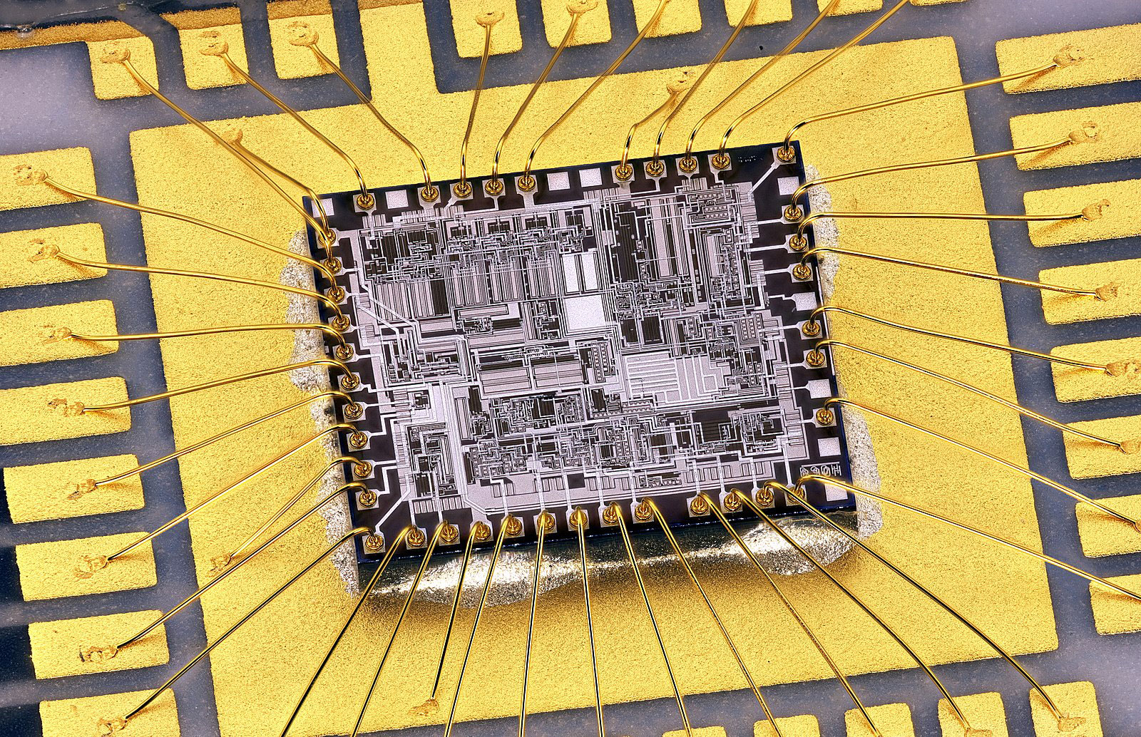 A wire-bonded Motorola GM350 transceiver. Note the gold wires