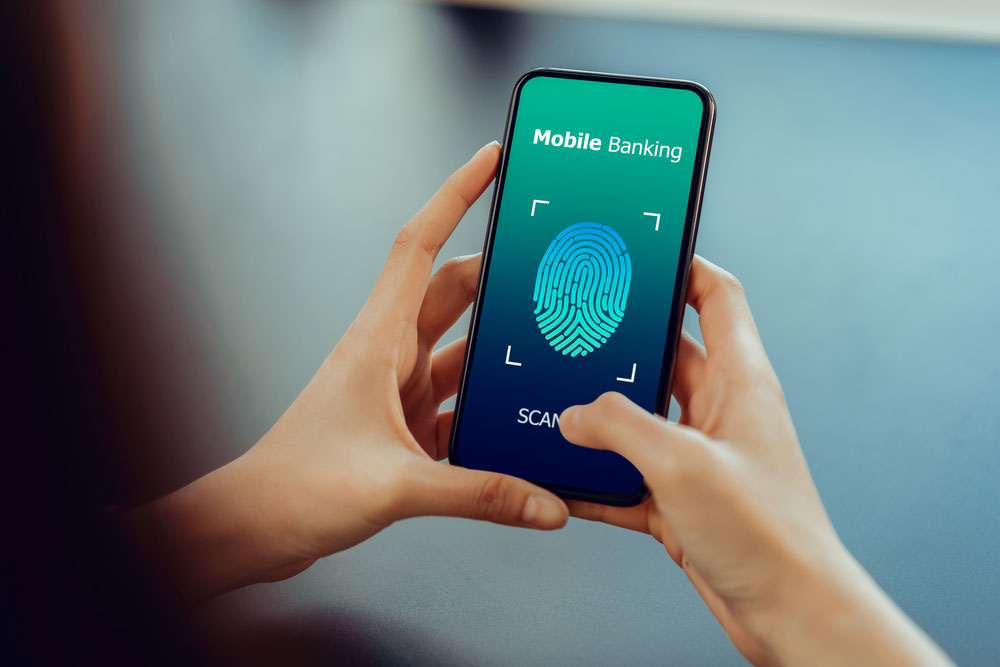 Fig 4: Hands Show the Fingerprint Scanner Screen to Access Online Banking