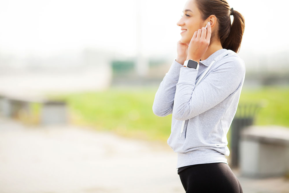 A young woman with Bluetooth Earpods