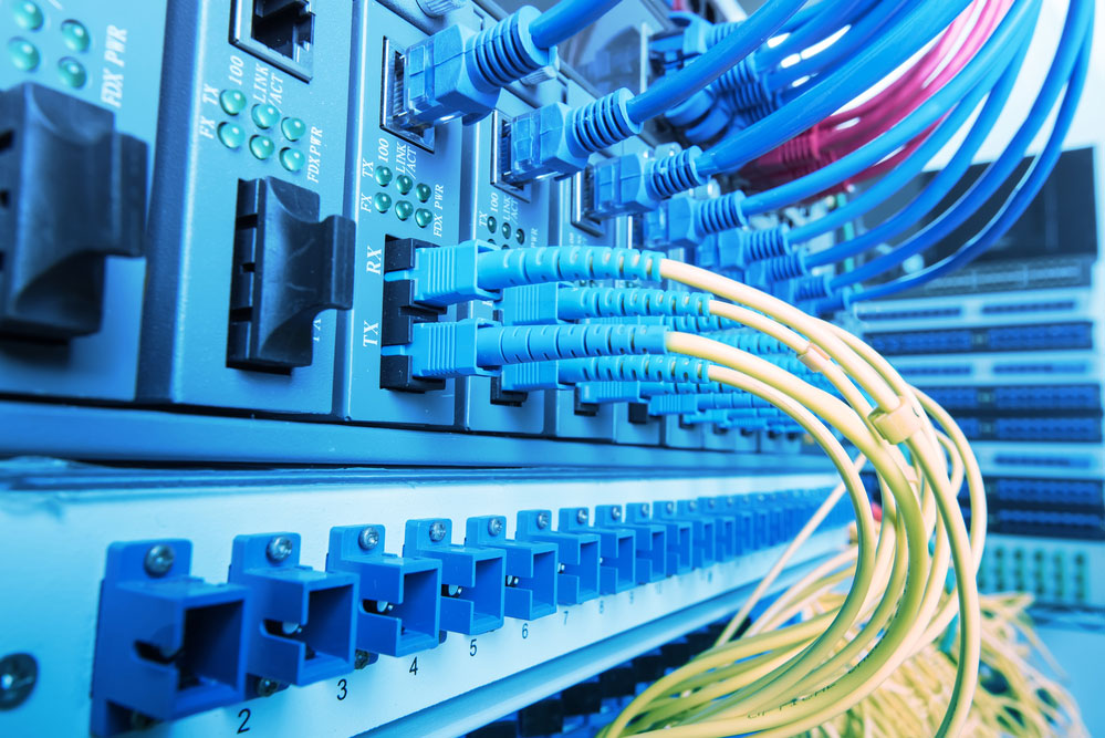 Fiber Optic cables connected to an optic port and Network cable