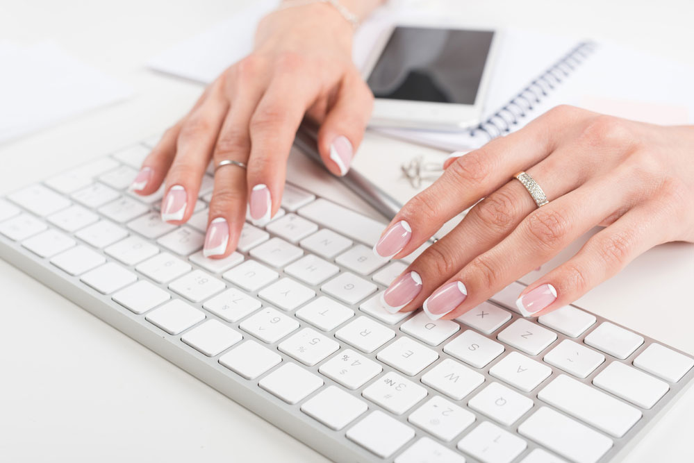 Woman typing on a keyboard