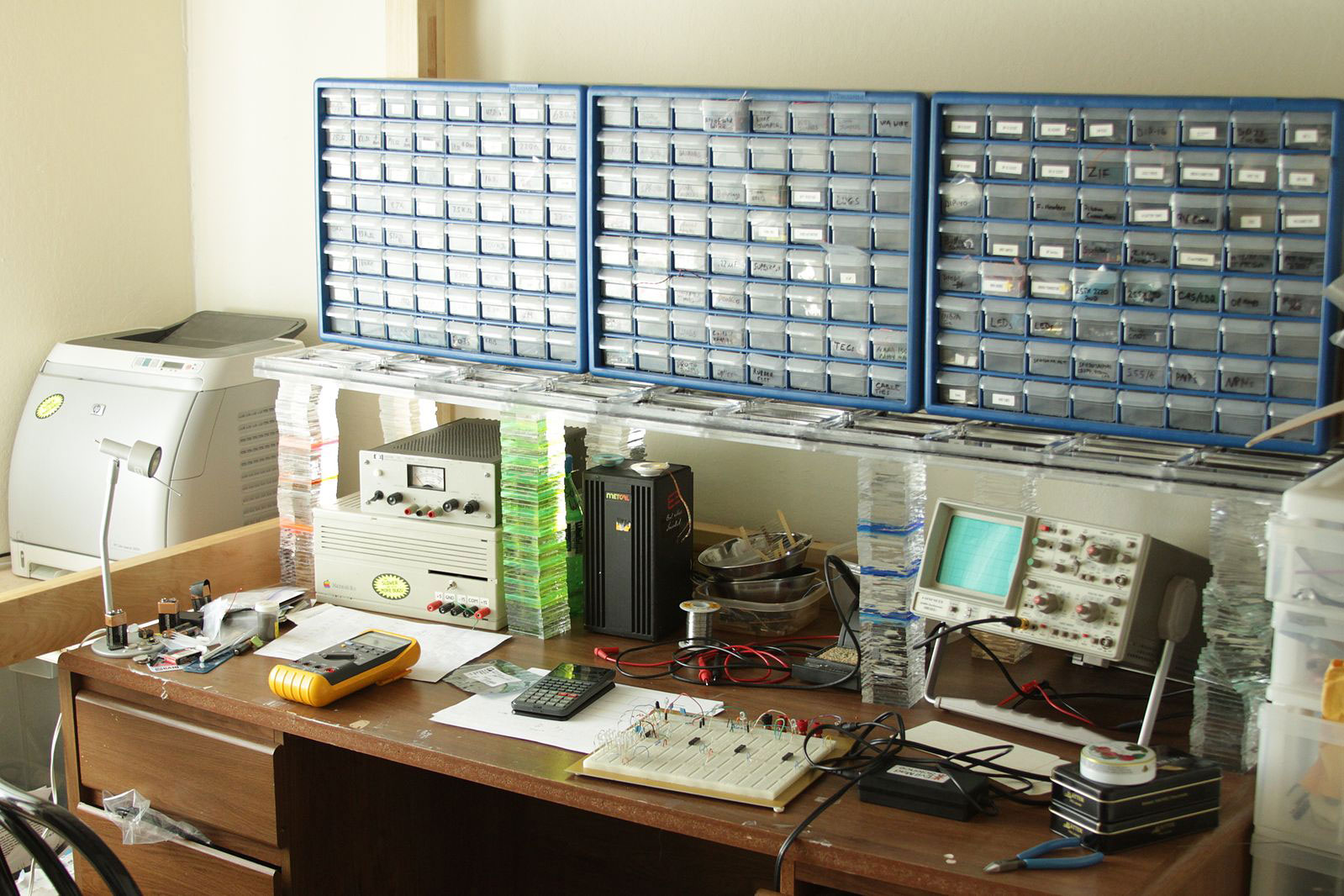 An electronics workbench. Note the numerous storage shelves against the wall