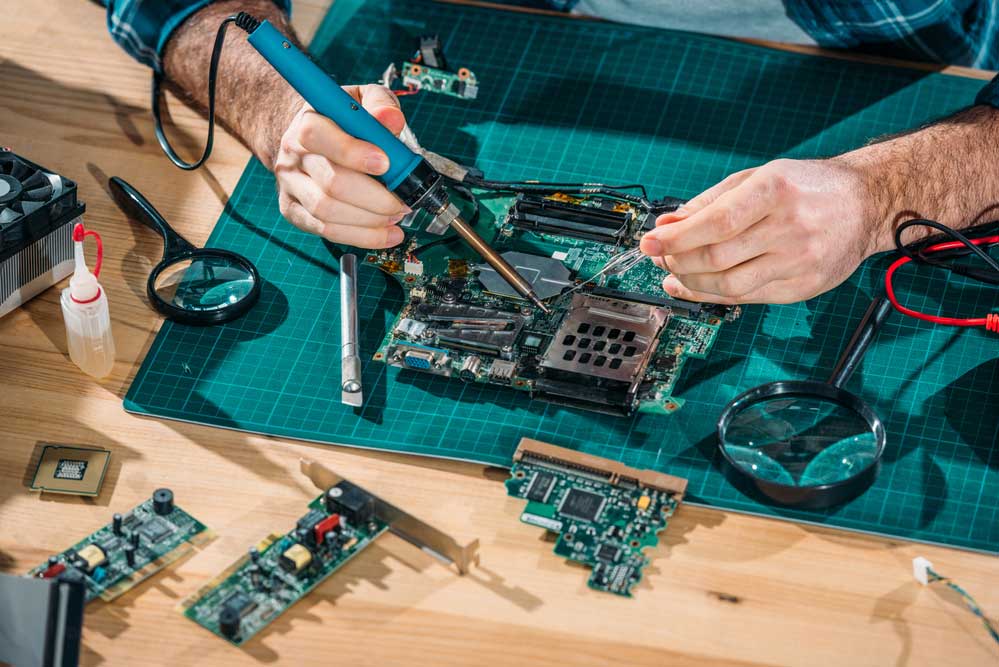 A close-up view of an engineer soldering 