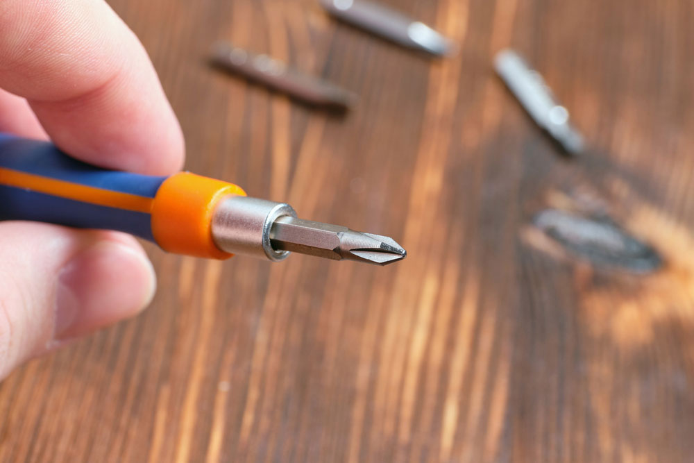 A screwdriver with a removable cross-shaped nozzle