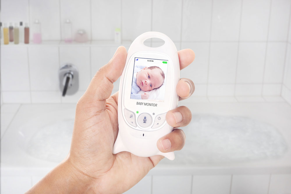 Parent checking newborn through the baby monitor