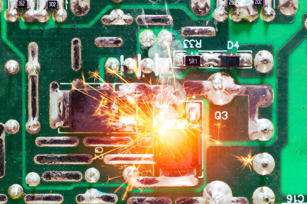 An electric short circuit burning out an overheated chip