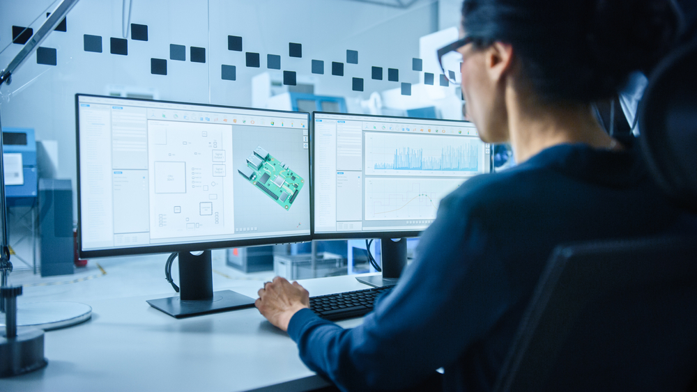 Female Electrical Engineer Works on Computer with CAD Software.