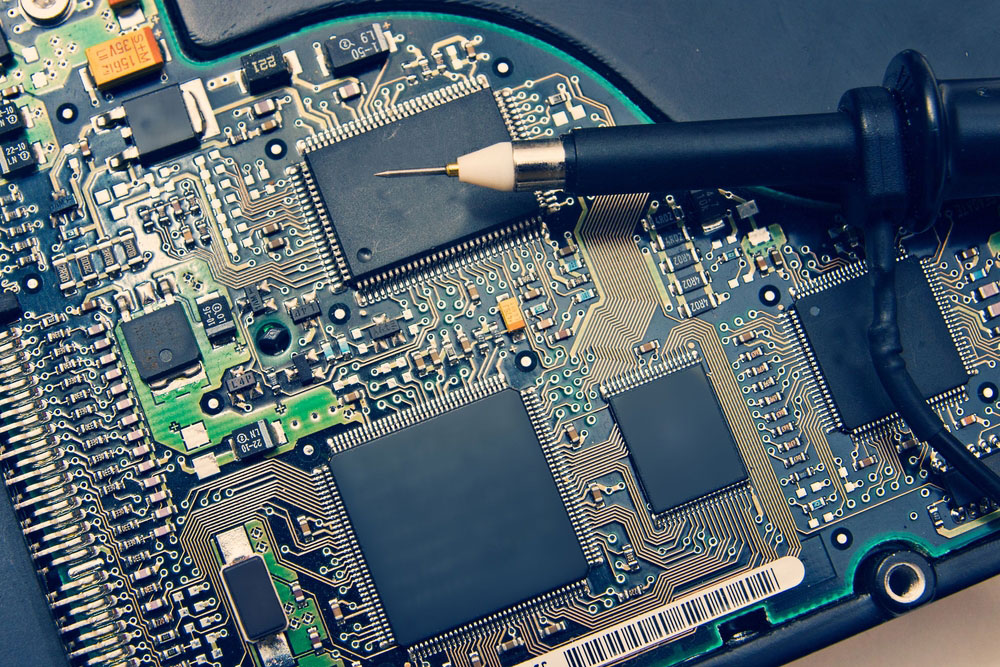 An oscilloscope probe on a high-density PCB