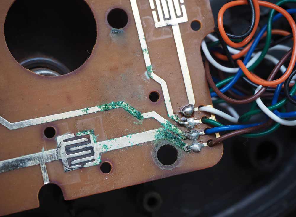 A PCB with corroded copper traces