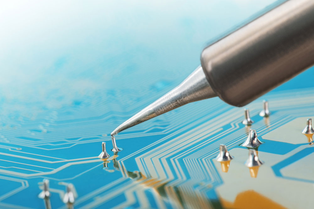 Through-hole component leads extending out of a PCB