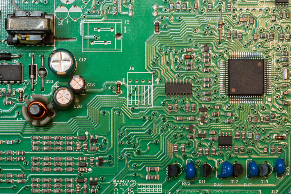 SMD green multi layer printed electronic circuit board with microcontroller and components